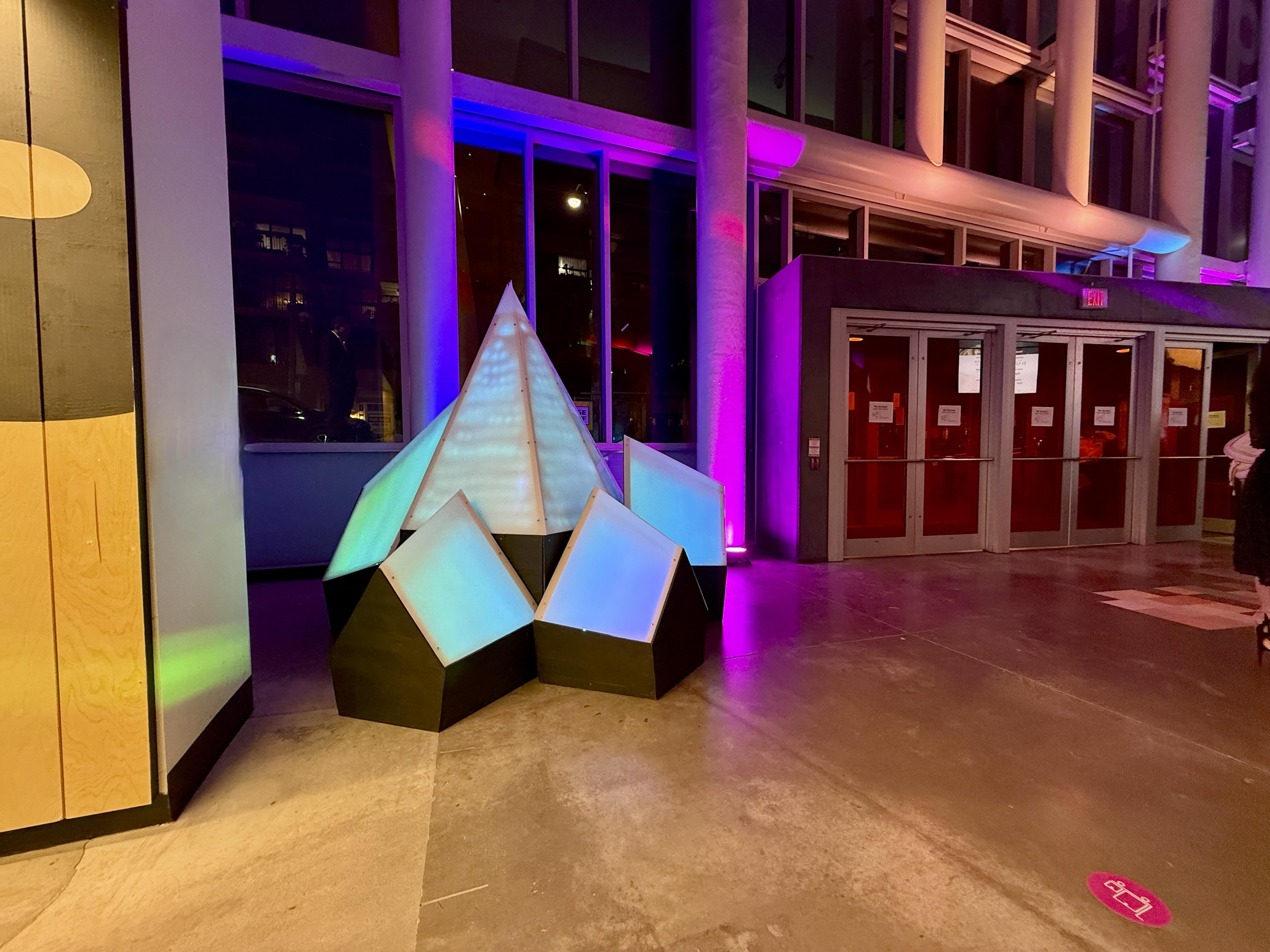 Constellation Range installation glowing inside the venue near the window and entrance.